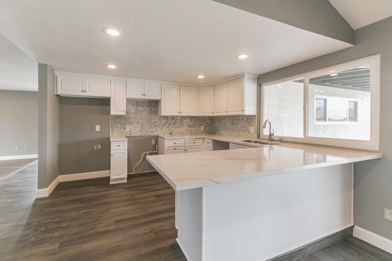 441 Debra Lane Ridgecrest, CA 93555 - Photo 9 of 30 a large kitchen with kitchen island a sink stainless steel appliances and cabinets