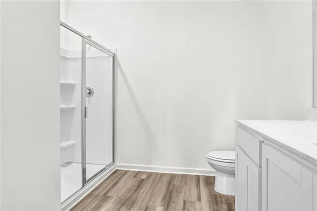 a bathroom with a toilet and a shower