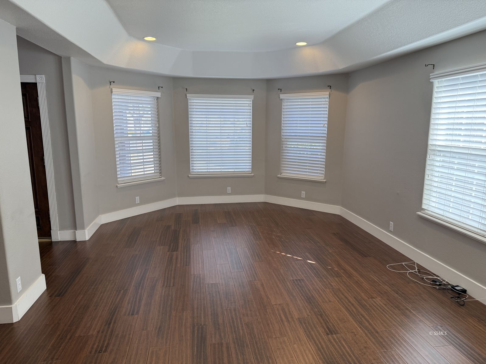 413 Laurkris Court Ridgecrest, CA 93555 - Photo 13 of 48 an empty room with wooden floor and windows