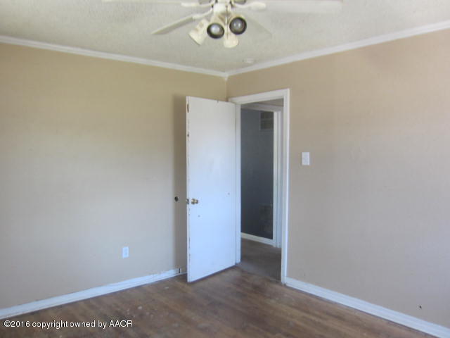 4021 Gables Street Amarillo, TX 79110 - Photo 3 of 14 an empty room with wooden floor