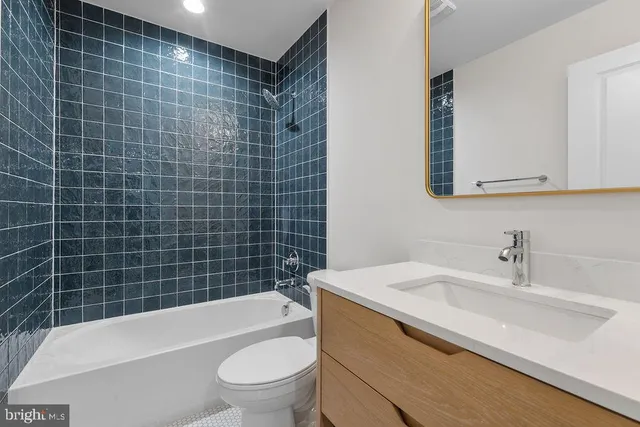 a bathroom with a sink a toilet and bathtub