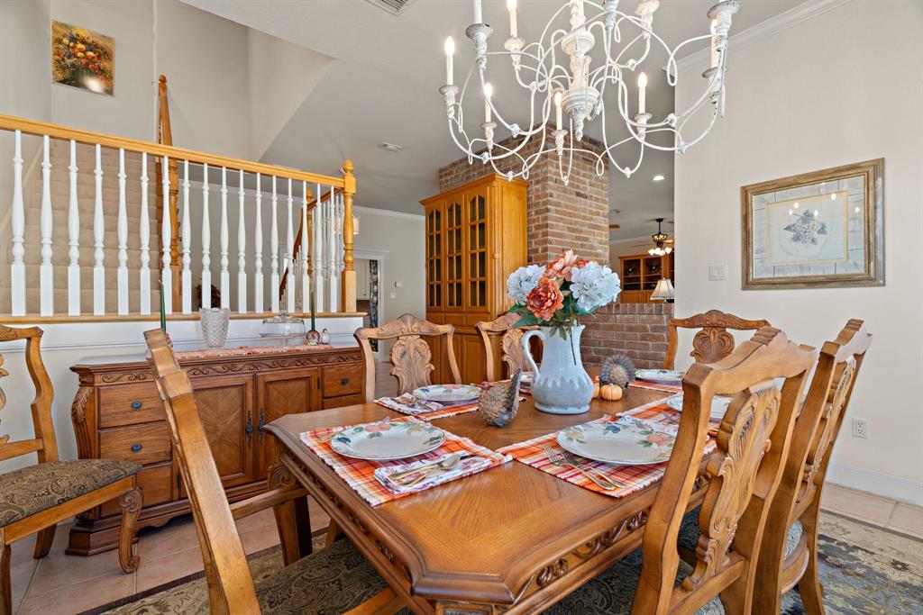 72 Crown Road Willow Park, TX 76087 - Photo 16 of 40 a view of a dining room with furniture a chandelier and wooden floor