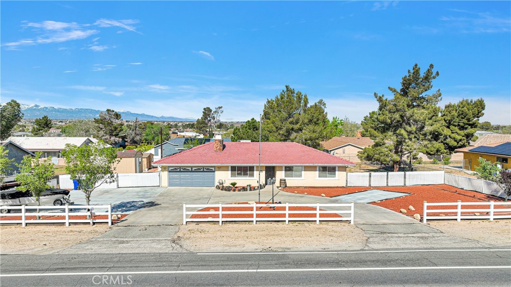 13976 Apple Valley Road Apple Valley, CA 92307 - Photo 1 of 1 a view of a tennis ground with large trees