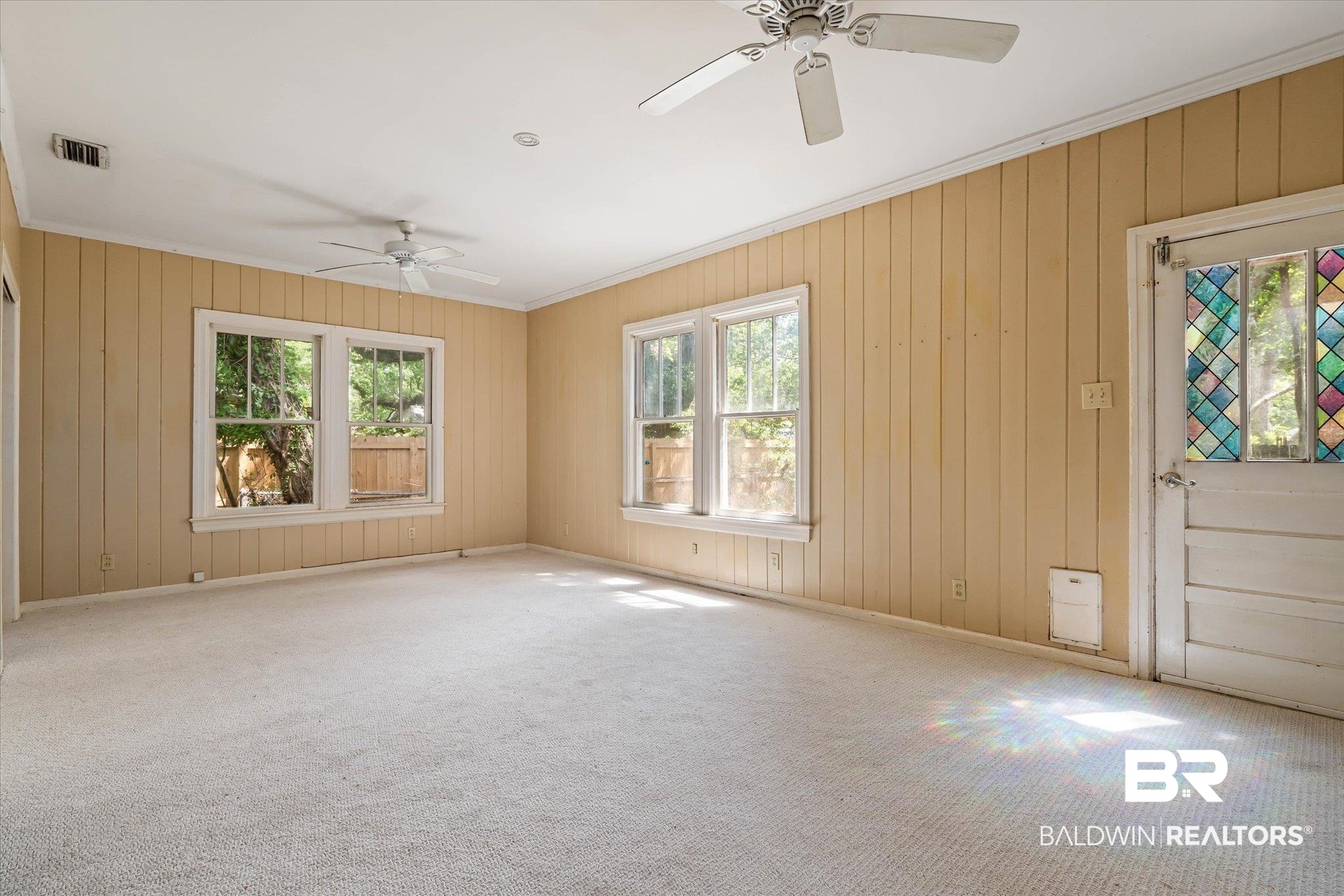 121 Westwood Street Mobile, AL 36606 - Photo 10 of 20 Carpeted empty room with plenty of natural light, visible vents, a ceiling fan, and ornamental molding