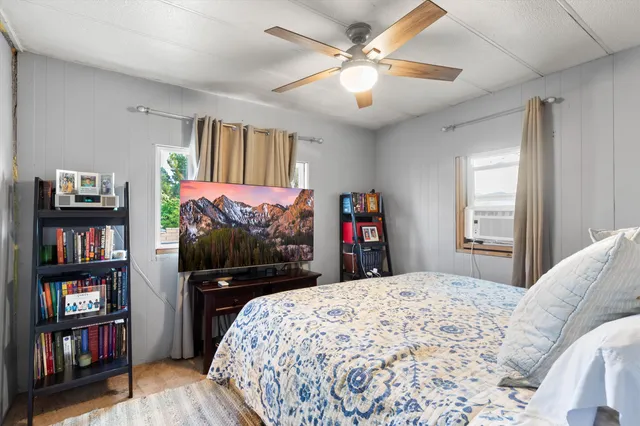 a bedroom with a bed and a flat screen tv