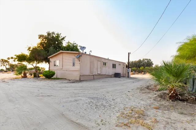 a view of a house with backyard and trees