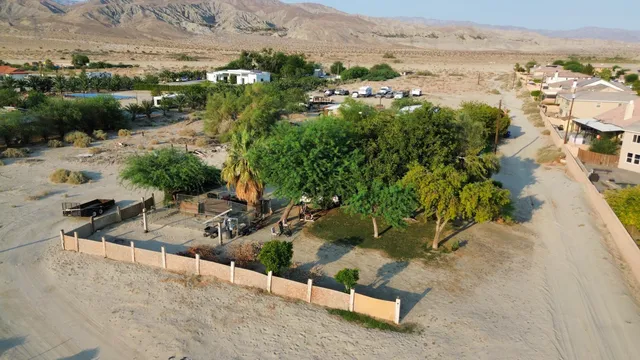 an aerial view of a house with a yard and lake view