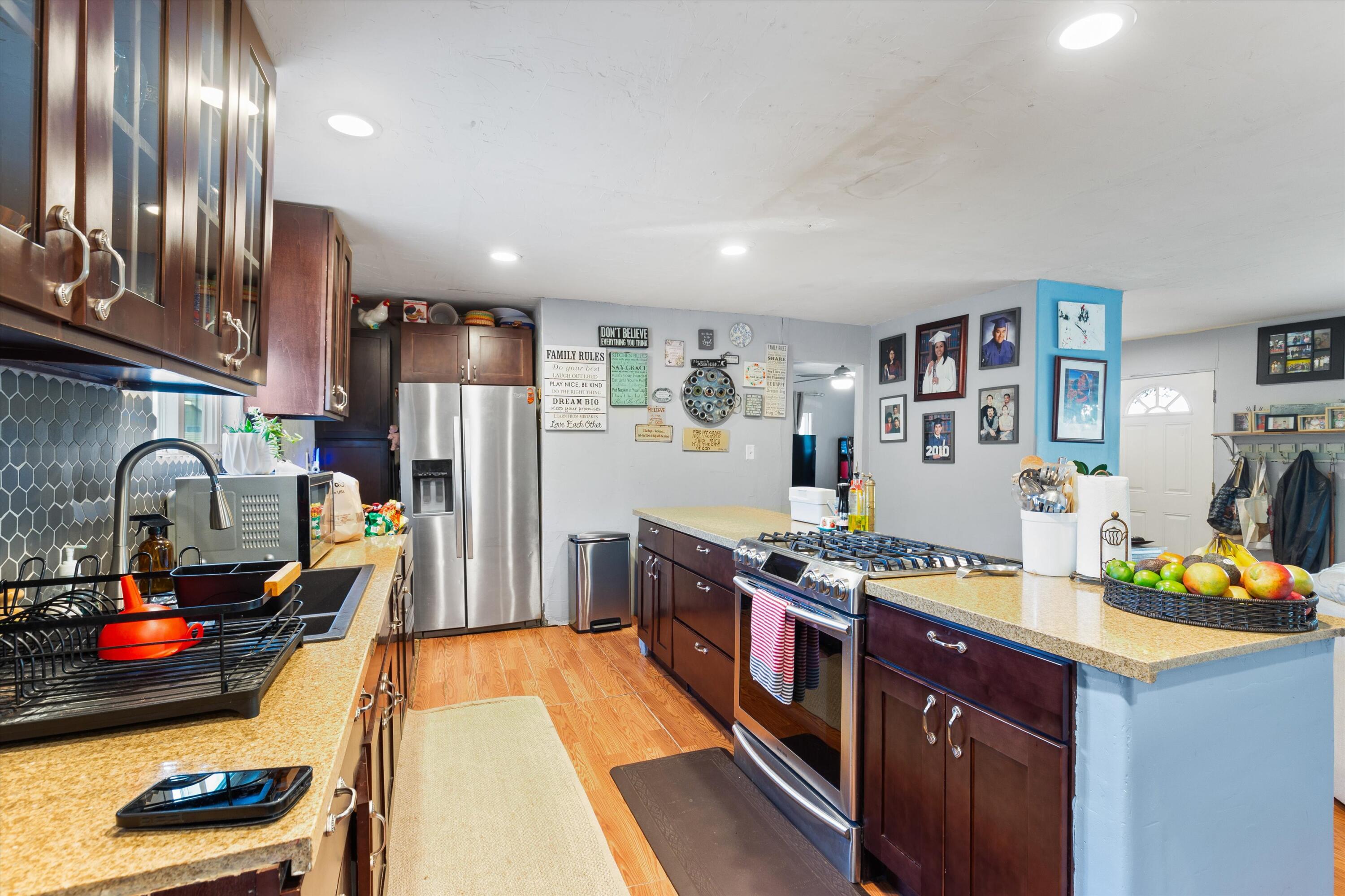 36990 Dune Palms Road Indio, CA 92203 - Photo 6 of 30 a kitchen with stainless steel appliances granite countertop a stove and a refrigerator