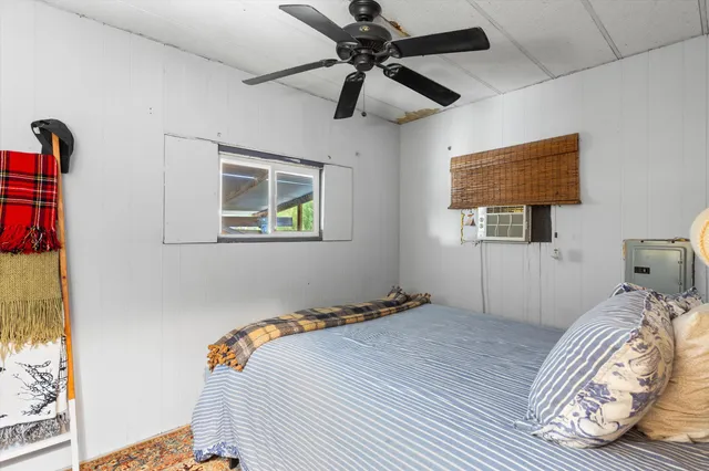 a bedroom with a bed and a window