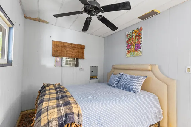 a bedroom with a bed and a painting on the wall