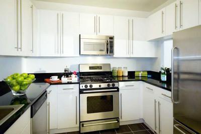 Undisclosed Address Manhattan, NY 10007 - Photo 14 of 15 a kitchen with a stove a sink and a refrigerator