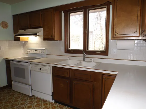a kitchen with a sink stove and cabinets