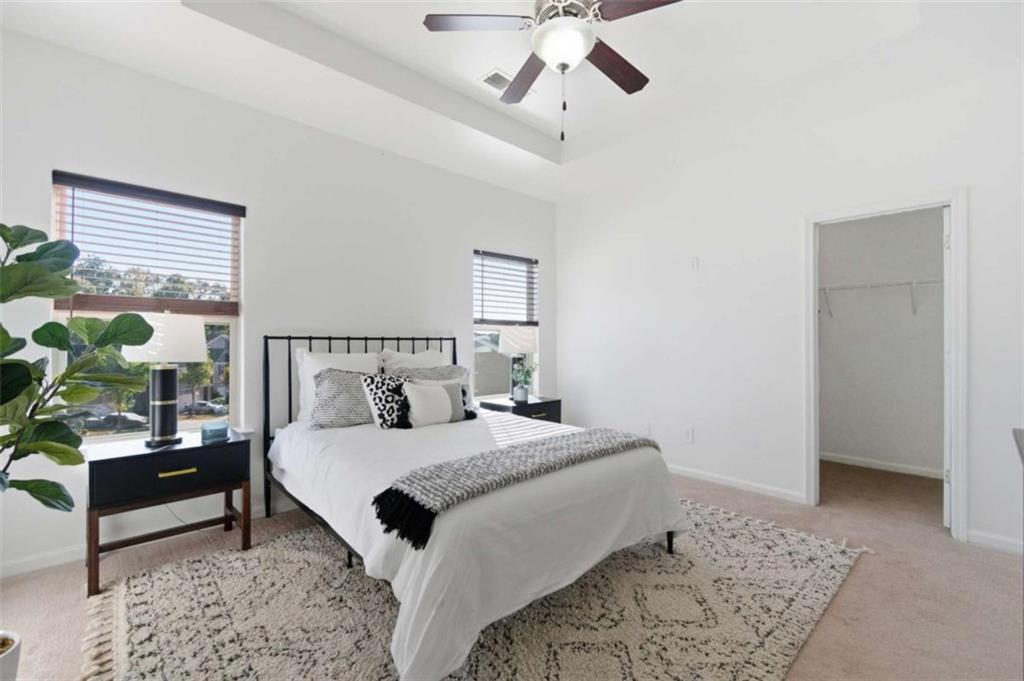 6872 Zaniah Road South Fulton, GA 30331 - Photo 13 of 29 a bedroom with a large bed and a chandelier