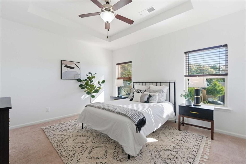 6872 Zaniah Road South Fulton, GA 30331 - Photo 14 of 29 a bedroom with a large bed and a chandelier