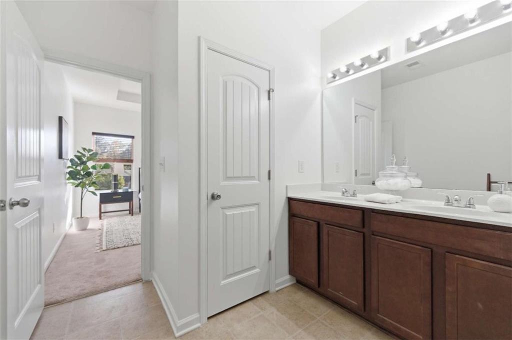 6872 Zaniah Road South Fulton, GA 30331 - Photo 15 of 29 a bathroom with a double vanity sink mirror and shower