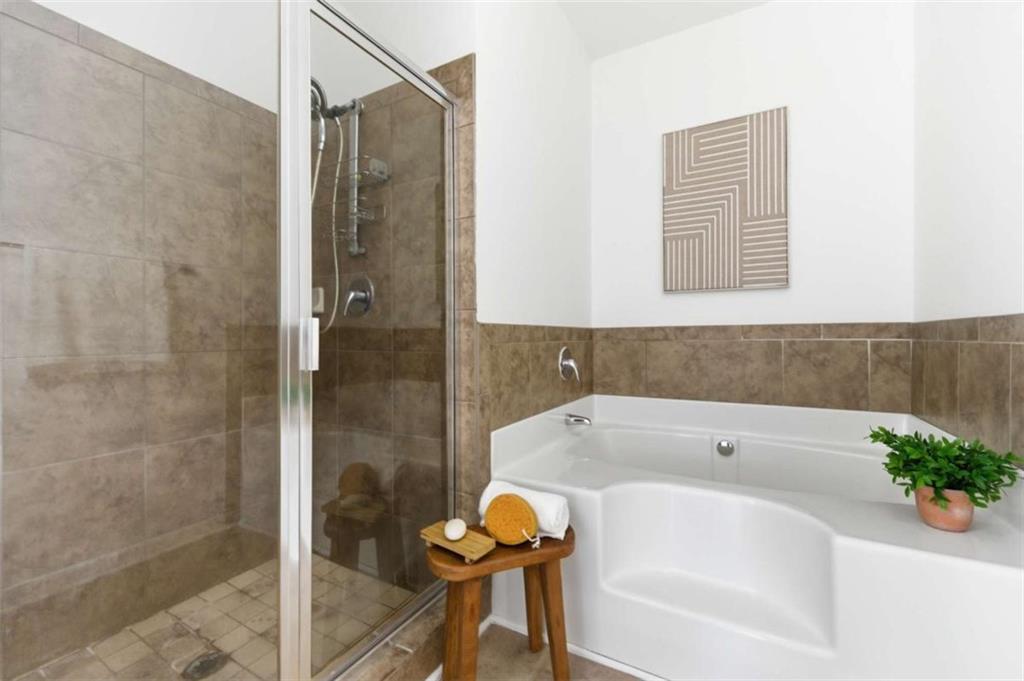 6872 Zaniah Road South Fulton, GA 30331 - Photo 16 of 29 a bathroom with a tub and shower