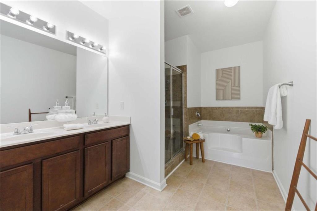 6872 Zaniah Road South Fulton, GA 30331 - Photo 17 of 29 a bathroom with a tub sink and mirror