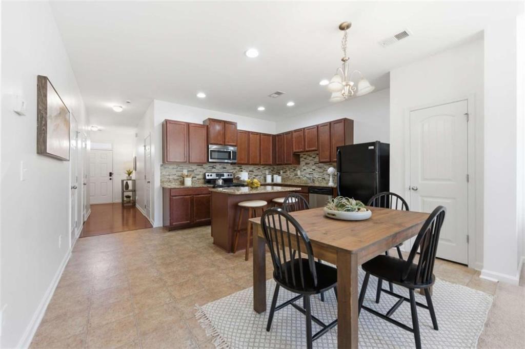 6872 Zaniah Road South Fulton, GA 30331 - Photo 8 of 29 a view of a dining room with furniture