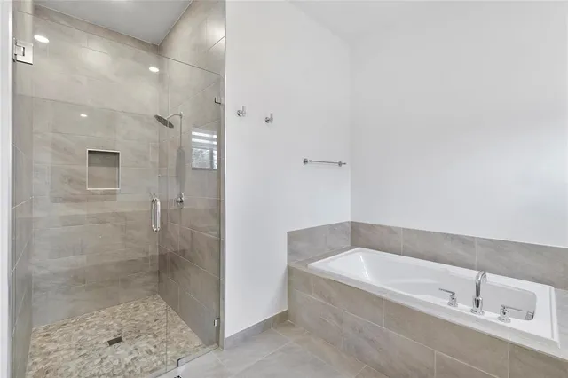 a spacious bathroom with a bathtub and shower