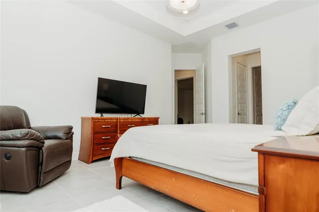 a bedroom with a bed and a flat screen tv