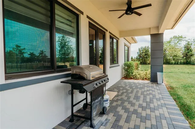 a view of a porch with furniture and a yard