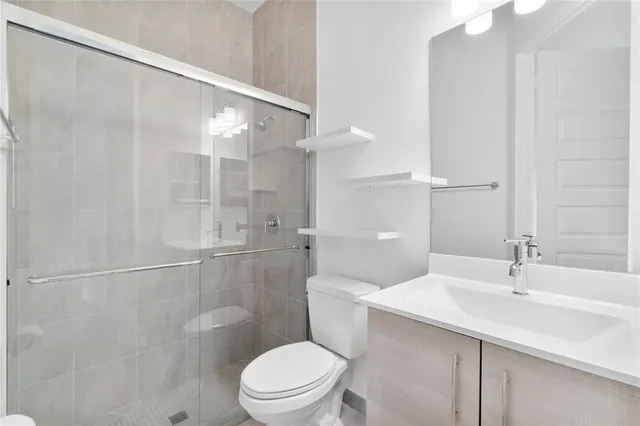 a bathroom with a toilet a sink and a shower