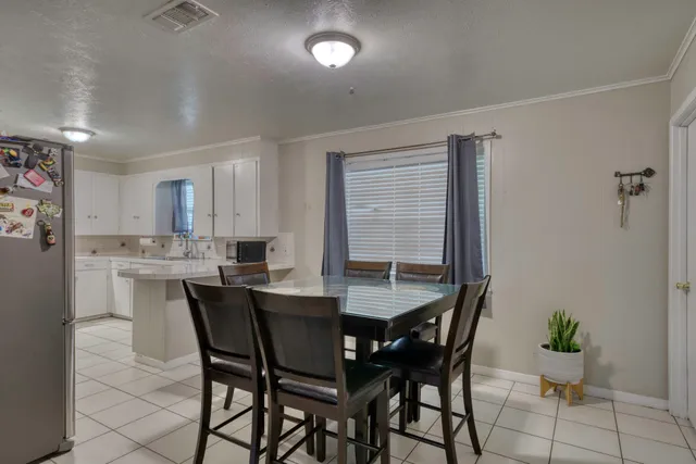 a dining room with furniture and window