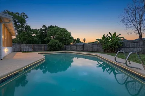 a view of a swimming pool with a patio