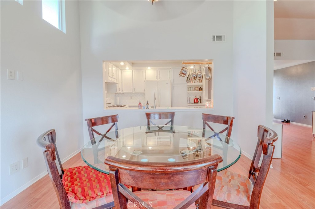 30630 Southern Cross Road Temecula, CA 92592 - Photo 19 of 42 a dining room with furniture and wooden floor