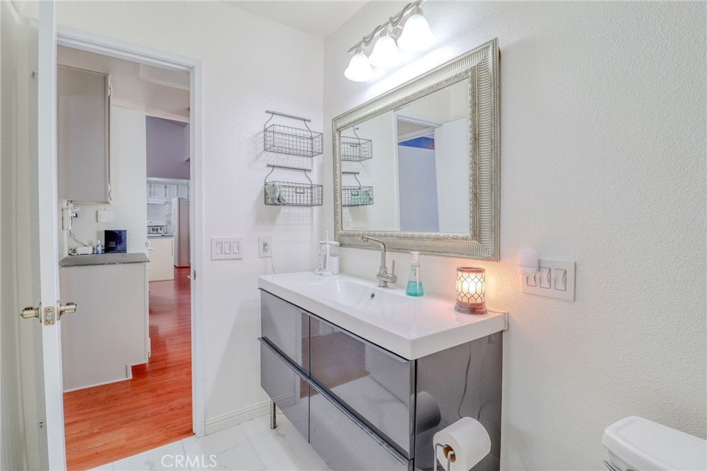 30630 Southern Cross Road Temecula, CA 92592 - Photo 24 of 42 a bathroom with a sink toilet and mirror