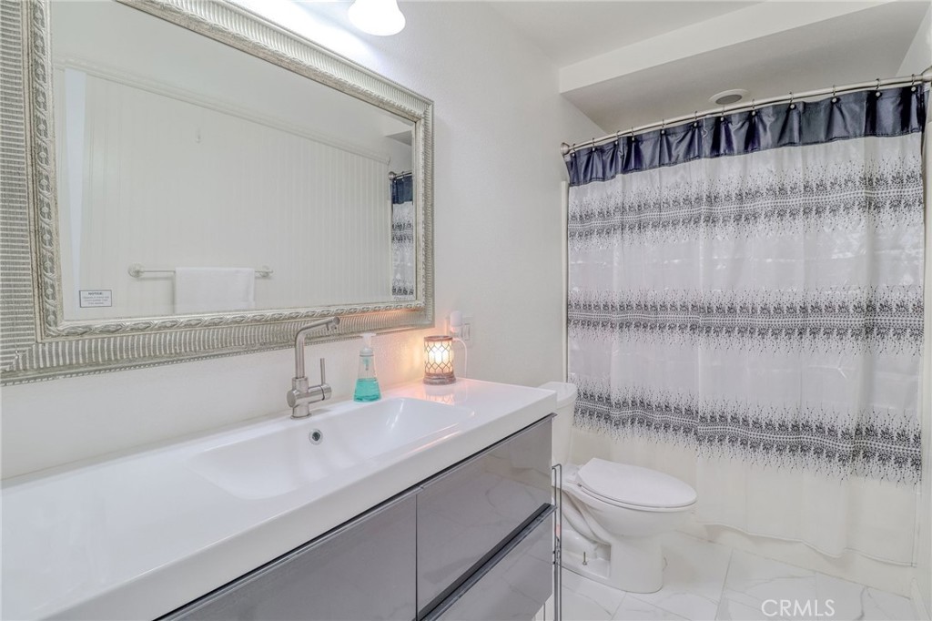 30630 Southern Cross Road Temecula, CA 92592 - Photo 25 of 42 a bathroom with a sink a toilet and shower