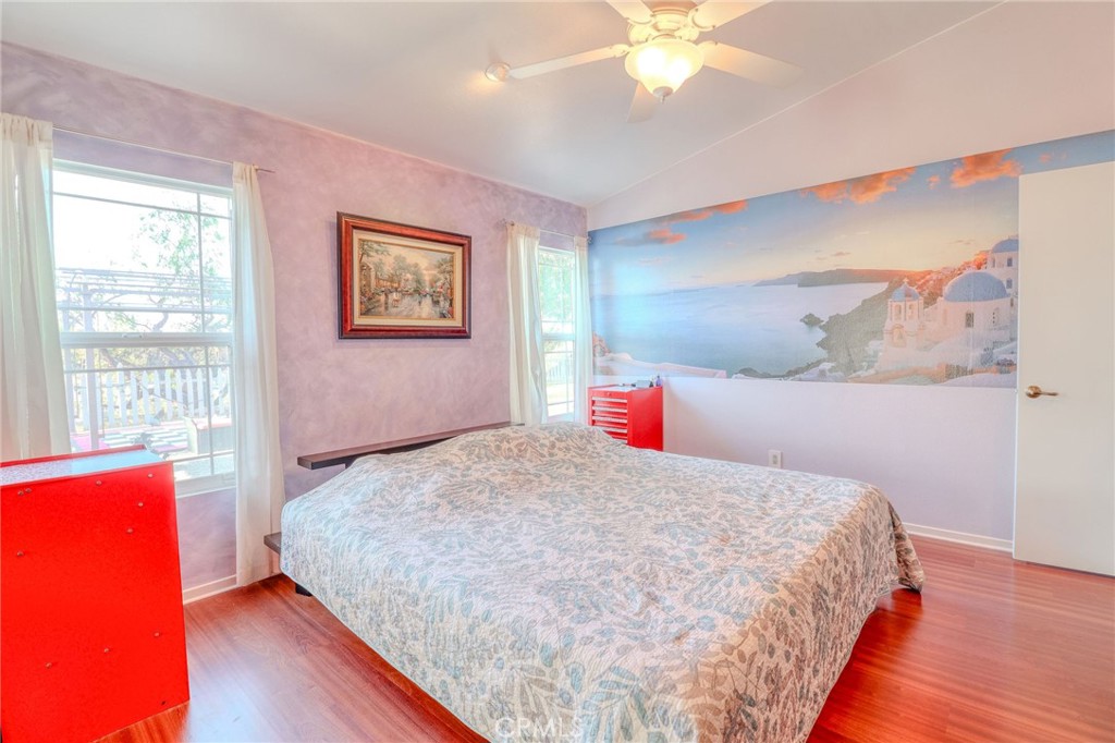 30630 Southern Cross Road Temecula, CA 92592 - Photo 26 of 42 a bedroom with a large bed and a chandelier