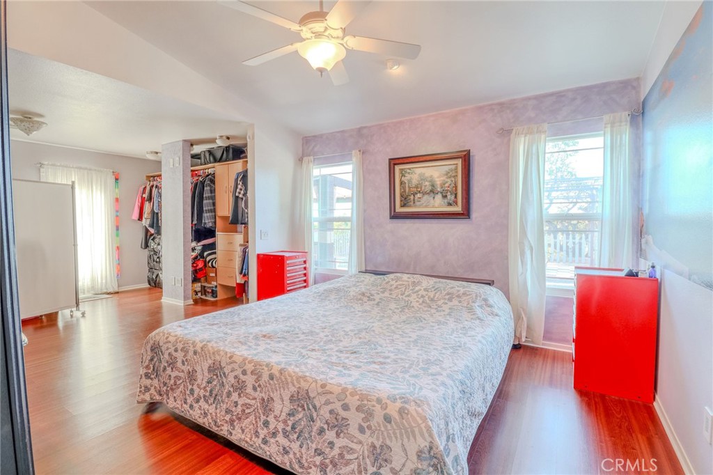 30630 Southern Cross Road Temecula, CA 92592 - Photo 28 of 42 a bedroom with a bed and a chandelier