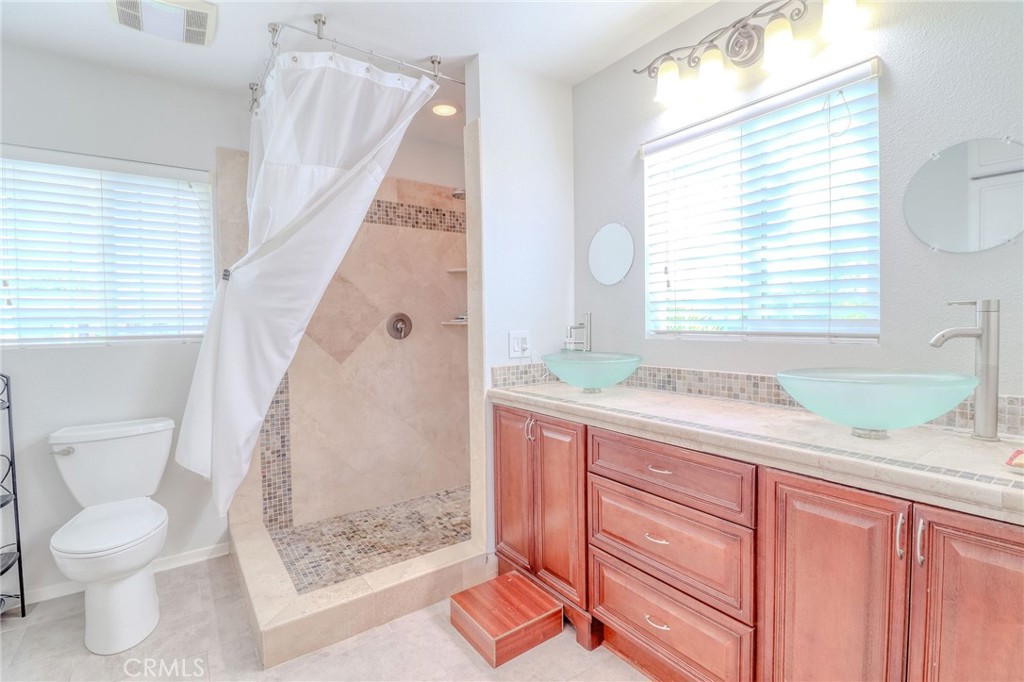 30630 Southern Cross Road Temecula, CA 92592 - Photo 31 of 42 a bathroom with a granite countertop sink toilet and shower