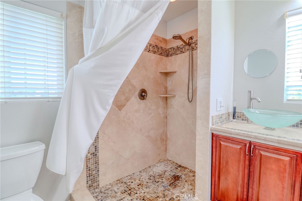 30630 Southern Cross Road Temecula, CA 92592 - Photo 32 of 42 a bathroom with a granite countertop sink toilet and shower