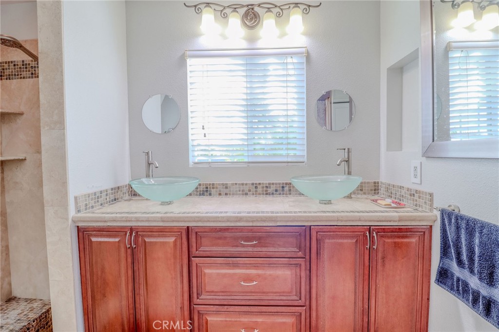 30630 Southern Cross Road Temecula, CA 92592 - Photo 33 of 42 a bathroom with a granite countertop sink and a window