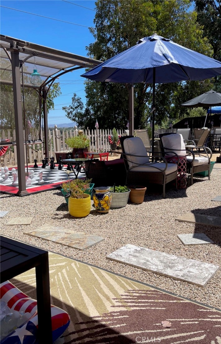 30630 Southern Cross Road Temecula, CA 92592 - Photo 36 of 42 a view of a backyard with sitting area and furniture