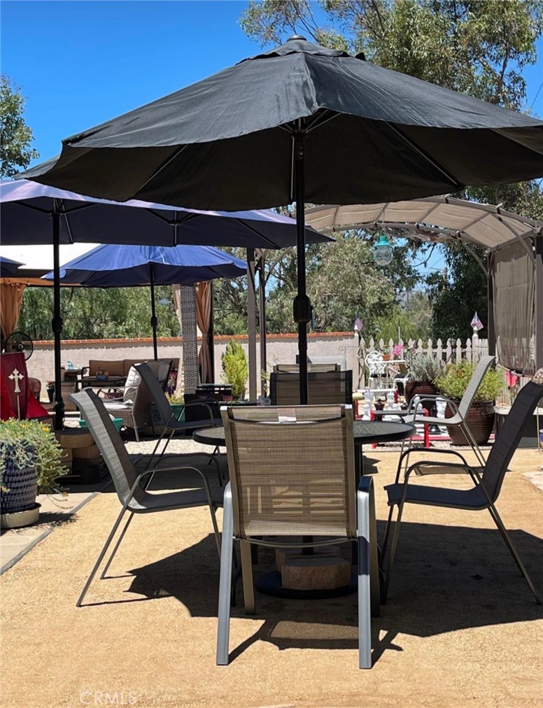 30630 Southern Cross Road Temecula, CA 92592 - Photo 37 of 42 a view of a patio with a table chairs and a umbrella