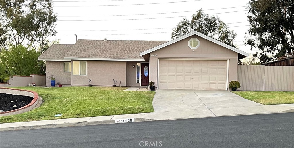 30630 Southern Cross Road Temecula, CA 92592 - Photo 4 of 42 a front view of house with garage and yard