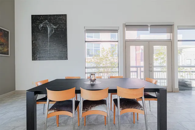a view of a dining room with furniture and a window