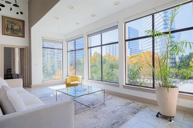 a living room with furniture and large windows