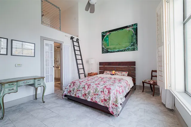 a living room with furniture and a dining table with floor to ceiling window