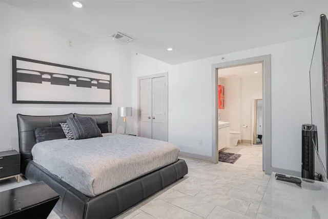 a en suite bathroom with a sink double vanity and a mirror