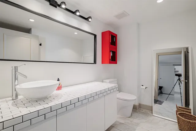 a bedroom with a bed and a mirror