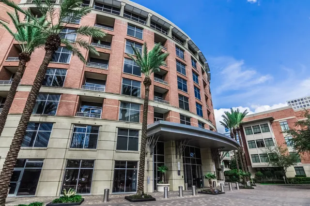 a bathroom with a granite countertop sink toilet and mirror