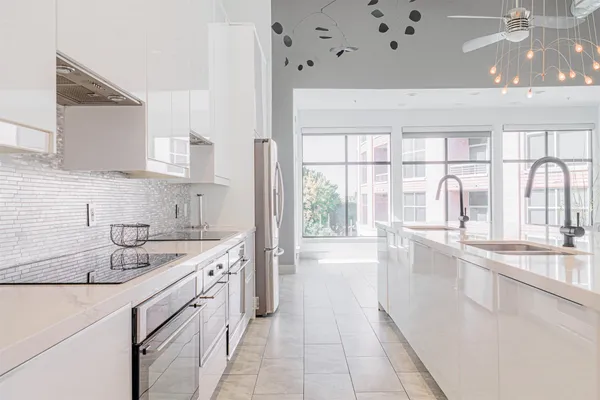a kitchen with a sink stove and cabinets