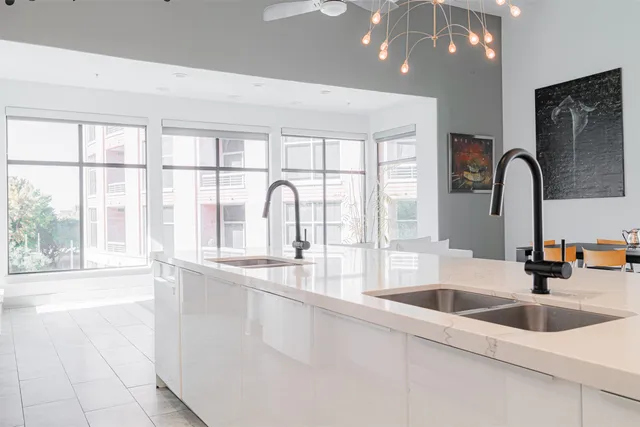 a kitchen with stainless steel appliances a sink and a large window