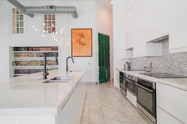 a kitchen with stainless steel appliances a sink stove and cabinets