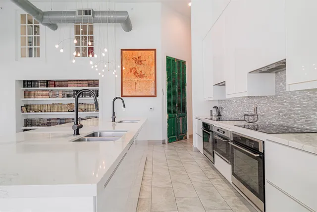 a kitchen with stainless steel appliances a sink stove and cabinets