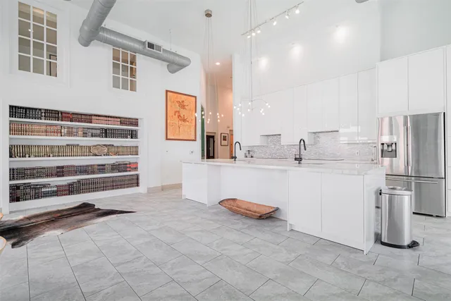a kitchen with refrigerator and cabinets